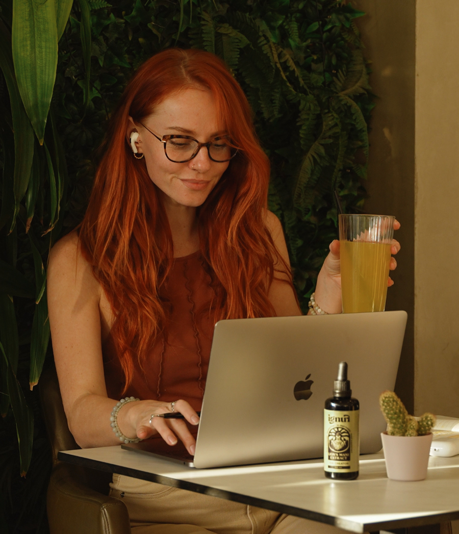 Woman working calmly at laptop with Lion's Mane extract